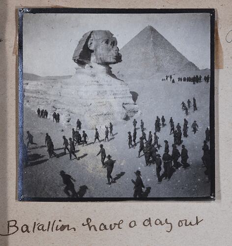 Photograph of men in military uniform with sphinx and pyramid in background, handwritten text below.