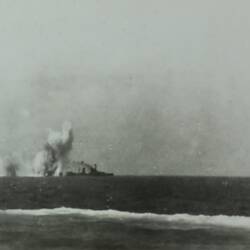 Navy ship in background, several explosions surround the shop, cannon in bottom right corner of foreground.
