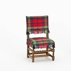 Wooden chair with tartan seat and back.