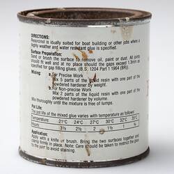 White tin with rusted lid. Black printing on label.
