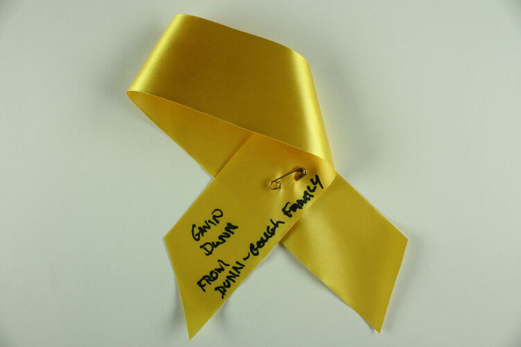 Yellow ribbon with black text.