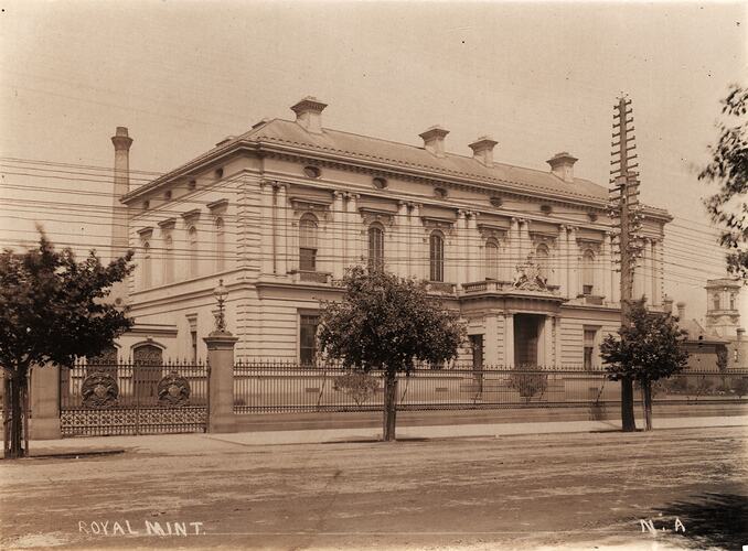Front entrance and forecourt of prominent building on corner.