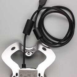 Black USB electrical cord attached to PC cradle.