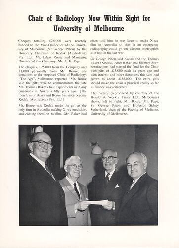 Article with photograph of men exchanging cheque.