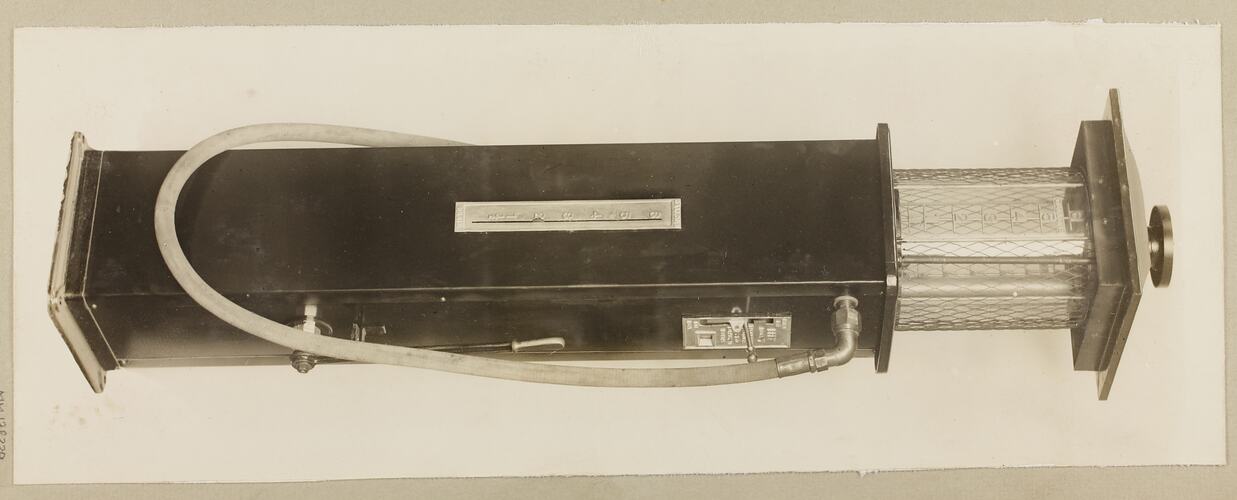 Monochrome photograph of a single cylinder petrol pump.