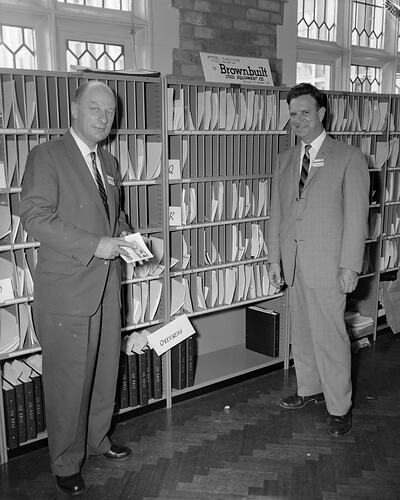 E.T. Brown Ltd, Pair Standing Near Shelving, Melbourne, 02 Mar 1960