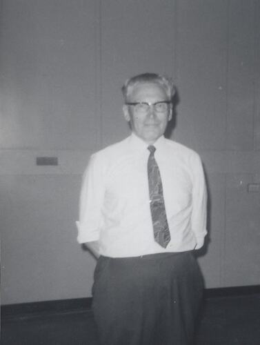Man in glasses,  shirt and tie.