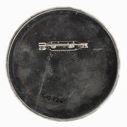 Metal back of round badge. Horizontal pin.