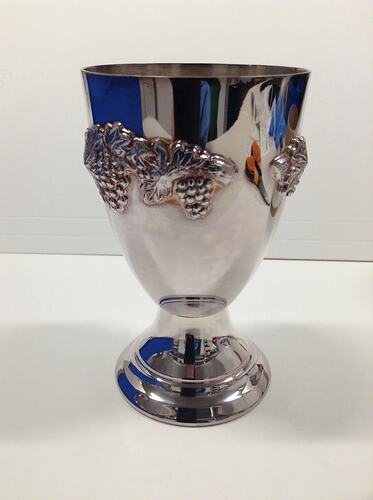 Silver goblet featuring grapevine design.