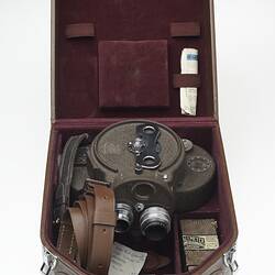Opened brown leather case displaying accessories.
