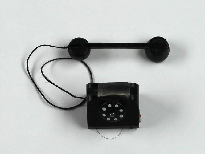 Toy telephone top view, handset lying down.