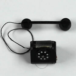 Toy telephone top view, handset lying down.