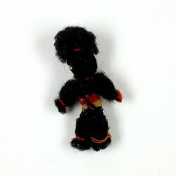 Back of tiny black wool doll.