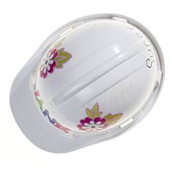 White plastic hard hat with multi-colour flower stickers on side and letter stickers on front. Top view.