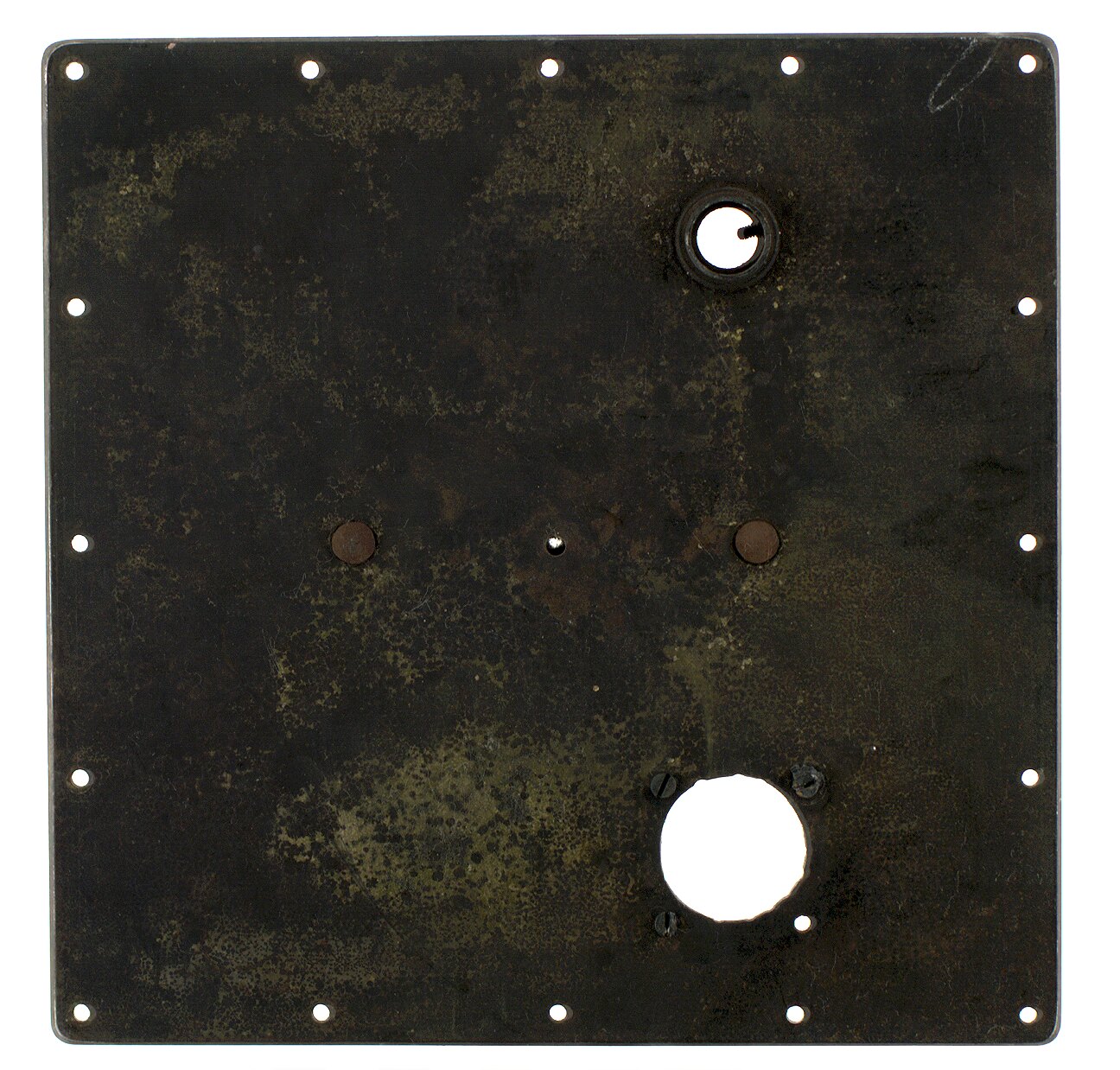A metallic rectangular device with wires and dials sits inside a testing chamber.