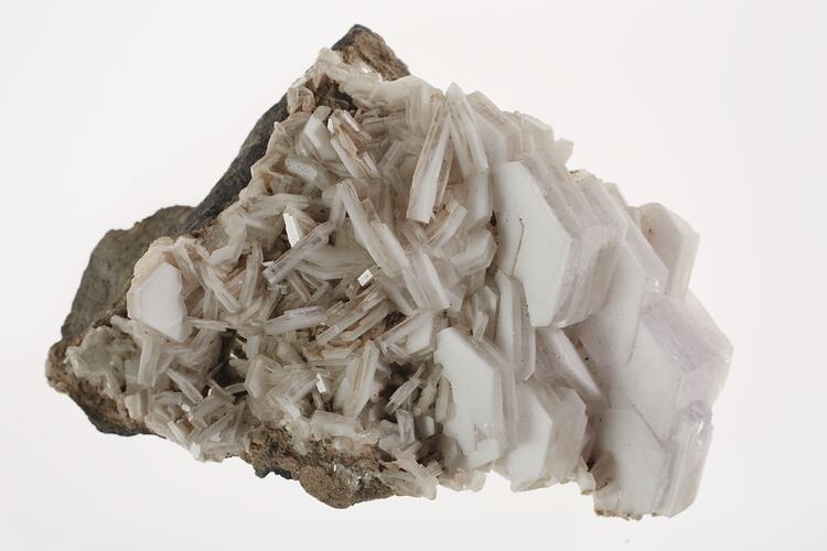 A pale pink mineral with pointy crystals.