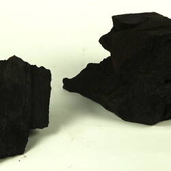 Two pieces of unprocessed coal.