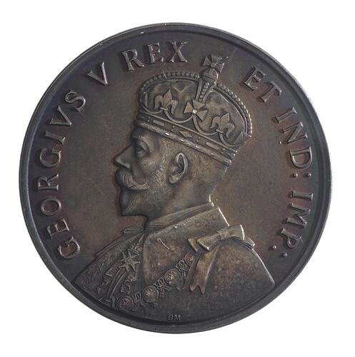 Round tarnised silver medal with bust of King facing left, wearing crown and formal attire. Text around.