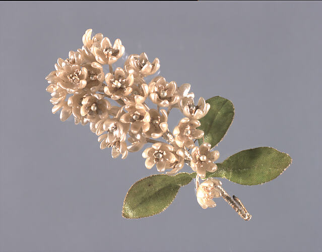 Artificial white lowers with 3 green leaves.