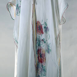 Long white robe with poppy pattern.