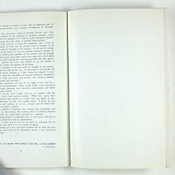 Open booklet with white pages and black printing on left side.