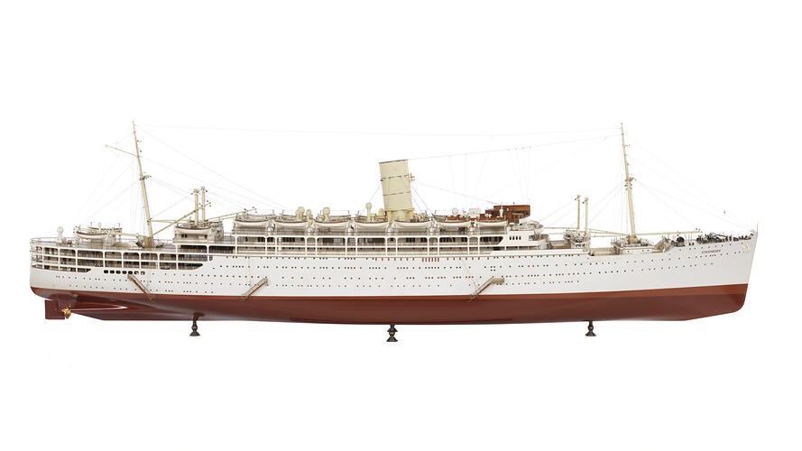 Ship model of white passenger & cargo liner with red base. One central funnel. Side view, facing right.