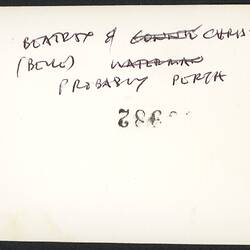 White back of photograph with black handwriting.