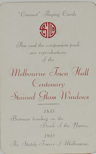 White playing card with black and red printed cursive text. Round red logo at top.