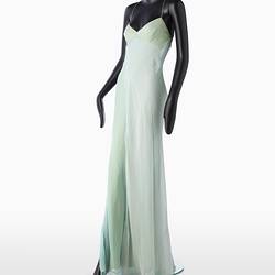 Full length pale green silk evening slip dress. Sleeveless. Flared/fishtail skirt with long slit at right.
