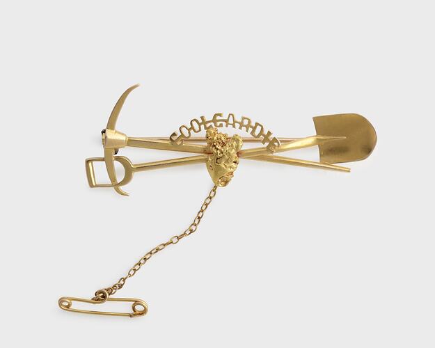 Gold miners brooch with pick and shovel motif.