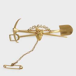 Gold miners brooch with pick and shovel motif.