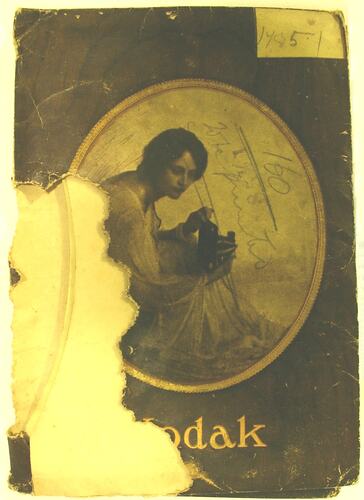 Paper Kodak wallet with brown and white woman holding box browny camera. Numbered 1485.