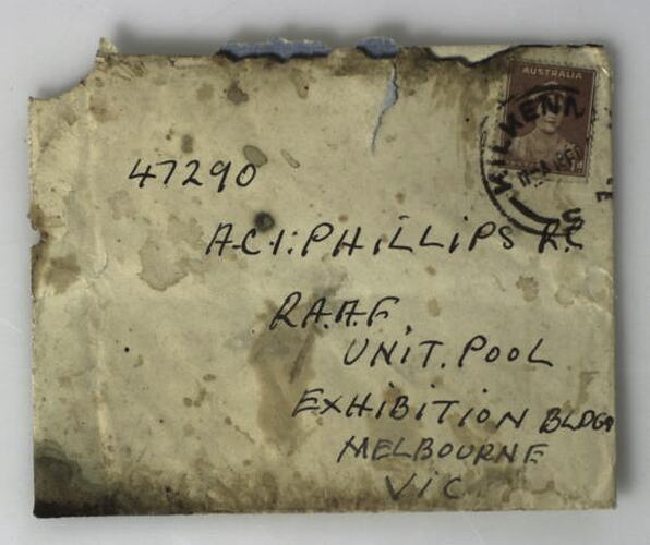 Stained envelope with red coloured stamp in top right corner. Handwritten address in black ink.