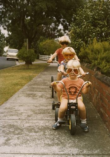 Three Children in Goggles Riding Bikes on Footpath, Brighton East, 1979