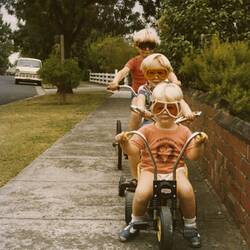Three Children in Goggles Riding Bikes on Footpath, Brighton East, 1979