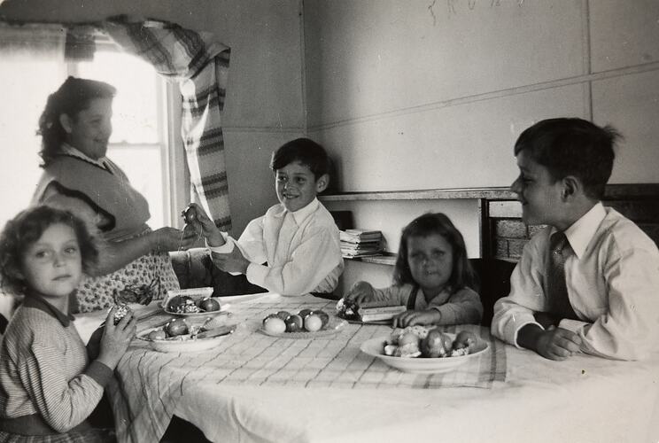 Mother, Two Girls & Two Boys playing 'Eierbecken' with Easter Eggs, Ringwood East, 1956