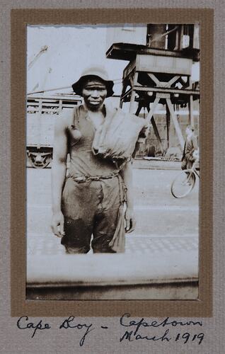 Man in tattered clothing and hat.
