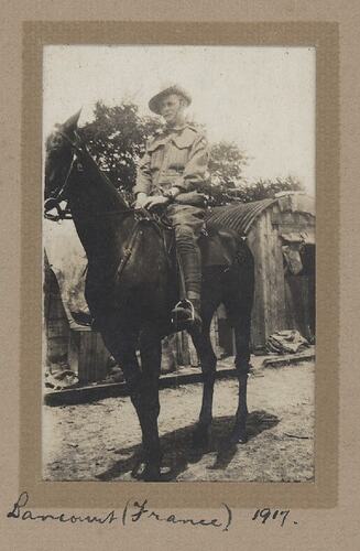 Man in military uniform on horseback.