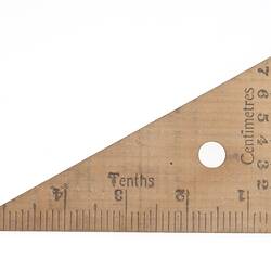 Triangular wooden set square with graded scales.