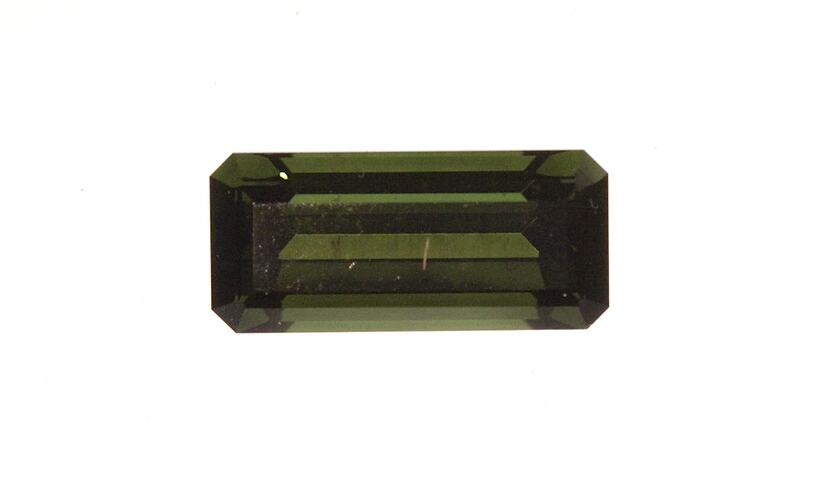 Rectangular faceted green gemstone specimen.
