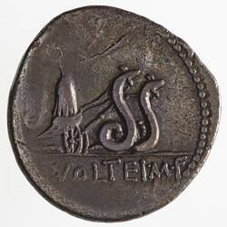 Round coin, aged, figure in chariot drawn by two snakes, holding two torches.