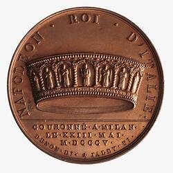 Round bronze medal with central crown. Text below and around.