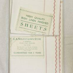 Front of bundle of sheets with labels.