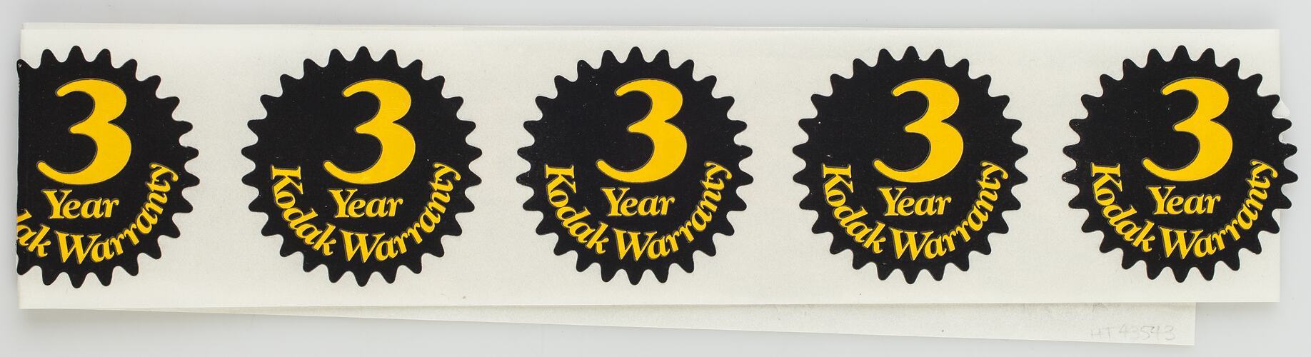 Strip of five black stickers with yellow printed text.