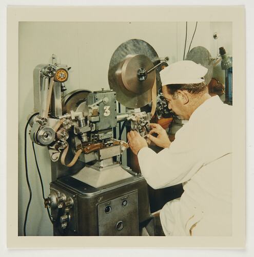 Slide 155, Worker Operating Perforating Machine, Kodak Factory, Coburg, 'Extra Prints of Coburg Lecture' album, circa 1960s