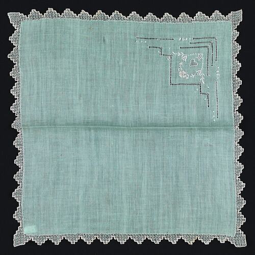 Unfolded Green Linen handkerchief with Embroidered Motif.