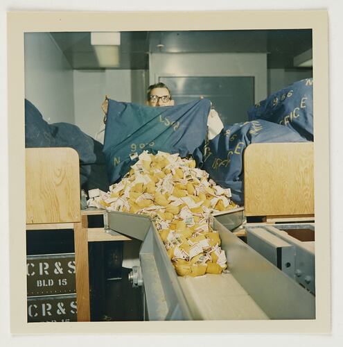 Slide 226, 'Extra Prints of Coburg Lecture', Worker Emptying Mail Bag of Films for Processing, Building 20, Kodak Factory, Coburg, circa 1960s