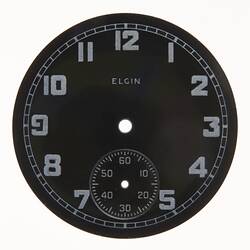 Round dark watch dial with light coloured numbers and markings.