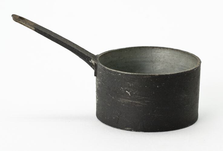 Miniature black saucepan from a doll's house.