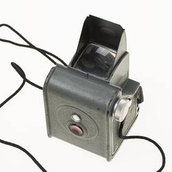 Grey metal camera. Top view shows square viewfinder surrounded by hood.